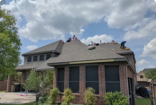 A couple of men working on a roof