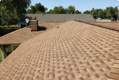 A brown roof with a chimney and a skylight